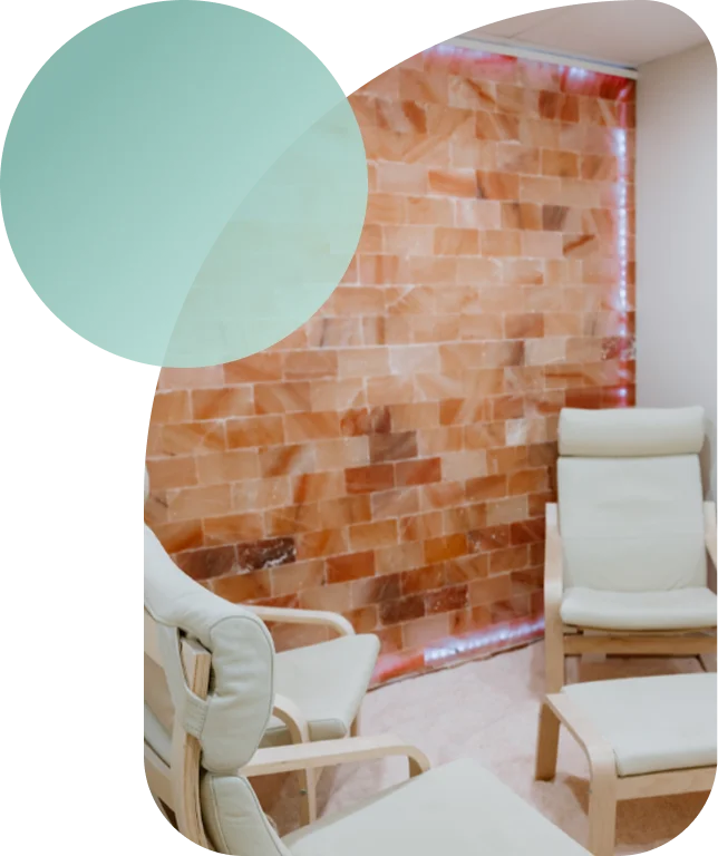 Salt brick wall and relaxation chairs at Breathe Salt Rooms