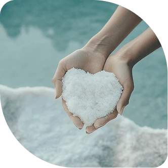 Heart-shaped salt held in hands, Breathe Salt Rooms salt therapy.