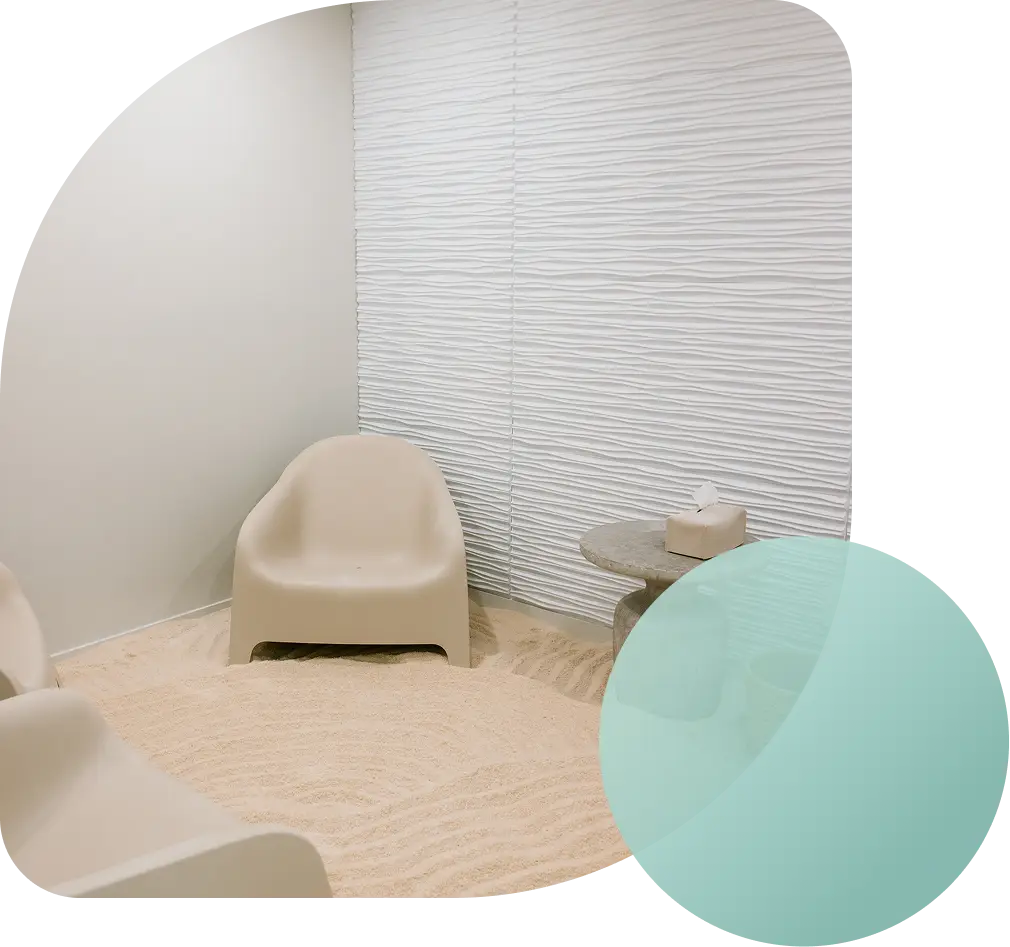 A single lounge chair on soft raked sand in a Breathe Salt Rooms salt room.
